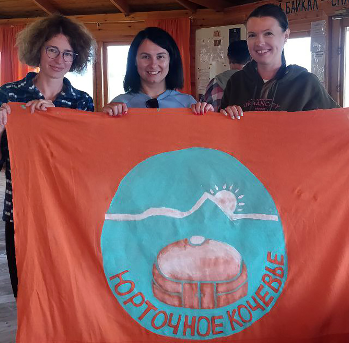 Участники фестиваля с нарисованным ими флагом Кочевья
